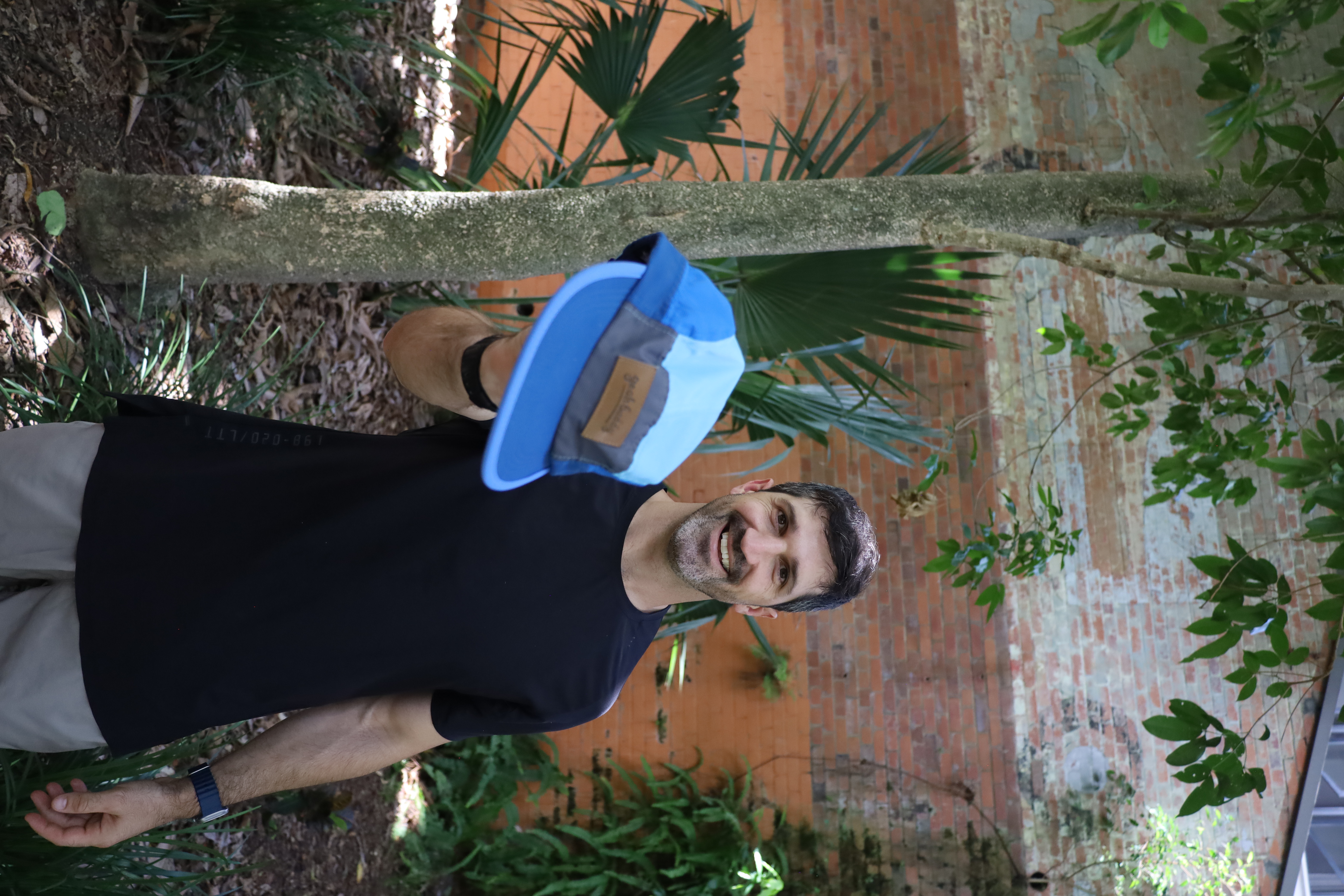 Lachlan Stuart holding a blue Yeah Buddy hat