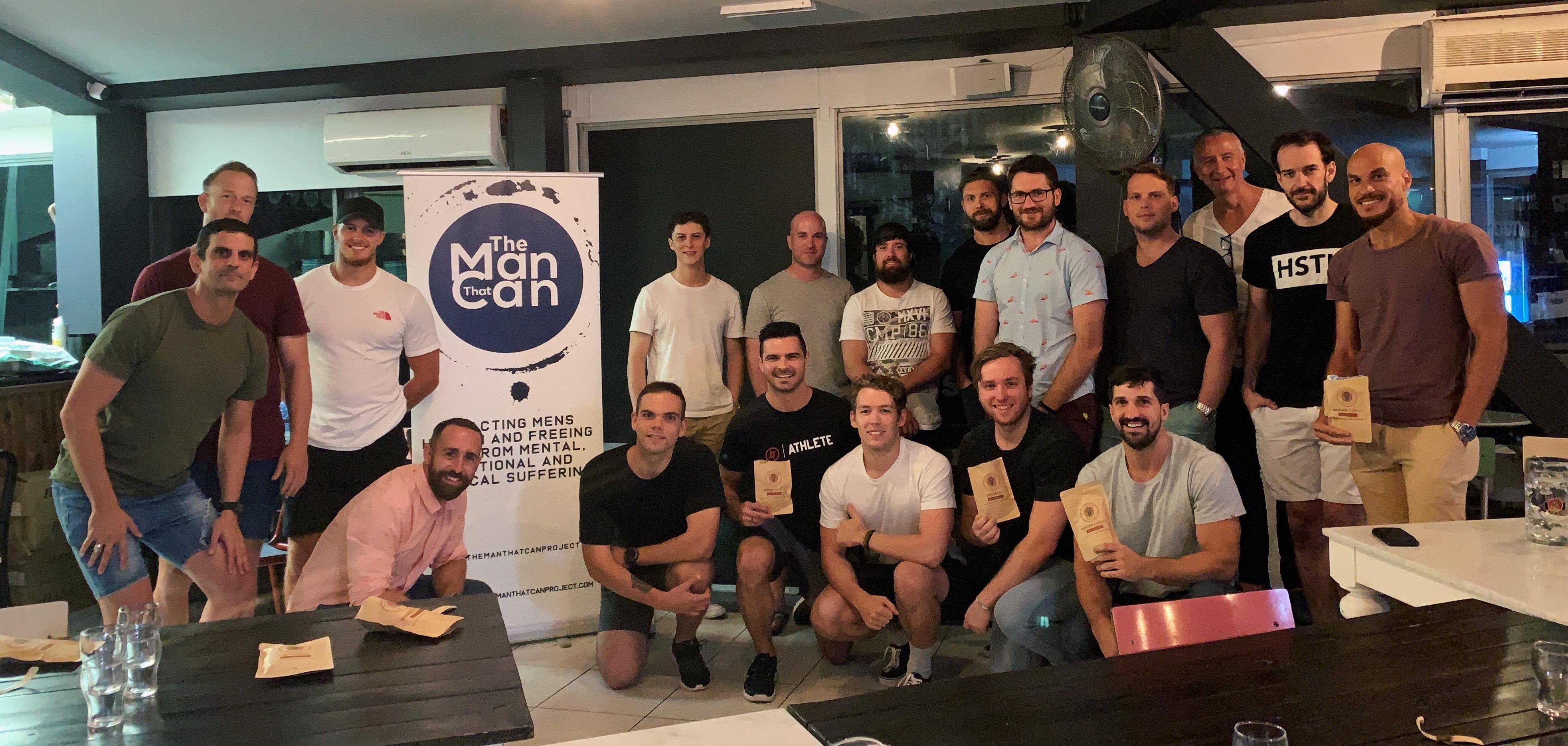 The Man That Can Project men's group photo with awards